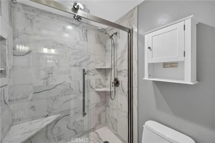 Hallway bathroom with dual-sinks and beautiful walk-in shower!