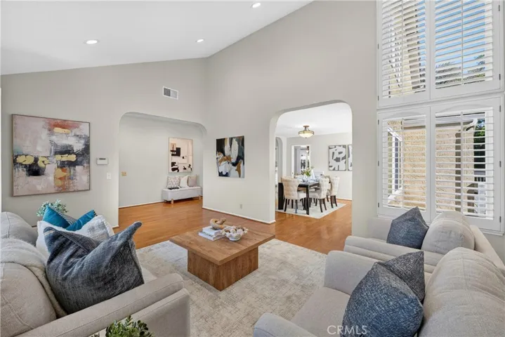 Step inside to a spacious living room filled with natural light and highlighted by soaring ceilings