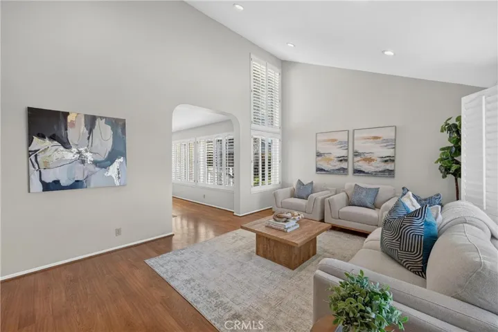 Step inside to a spacious living room filled with natural light and highlighted by soaring ceilings