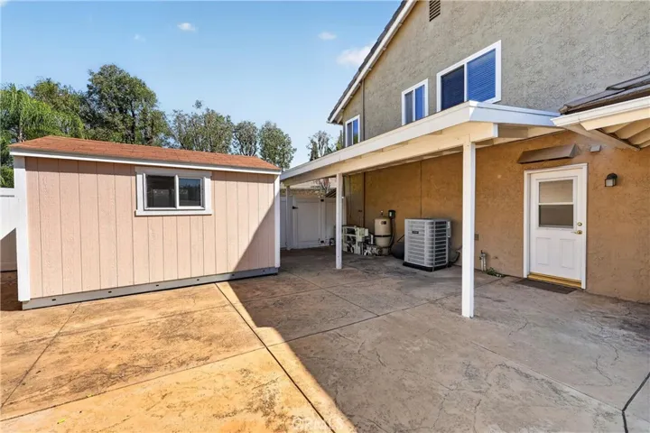 Additional outdoor patio area featuring a storage shed
