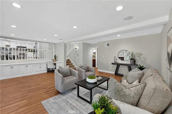 Spacious family room featuring a cozy fireplace and seamless access to the backyard