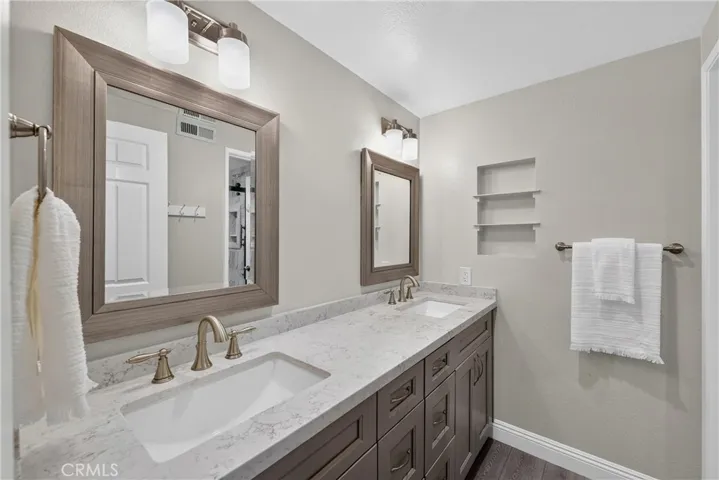 Hallway bathroom with dual-sinks and beautiful walk-in shower!