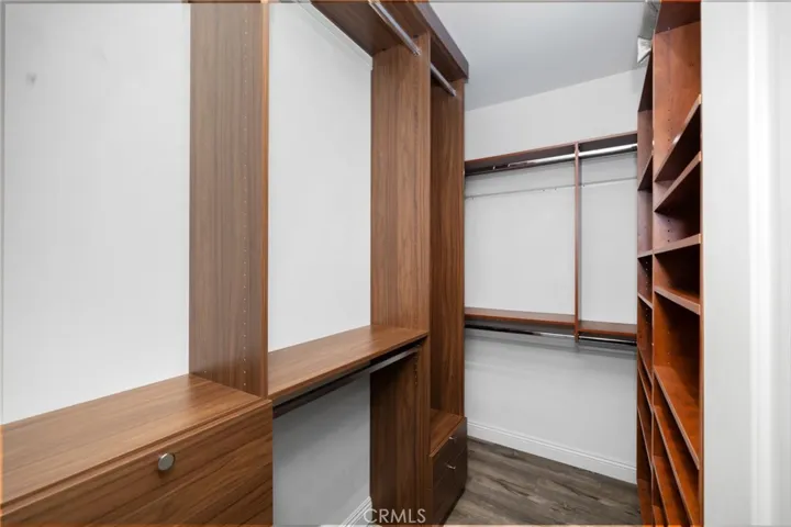 Primary En-Suite Walk-In Closet with Custom Cabinetry