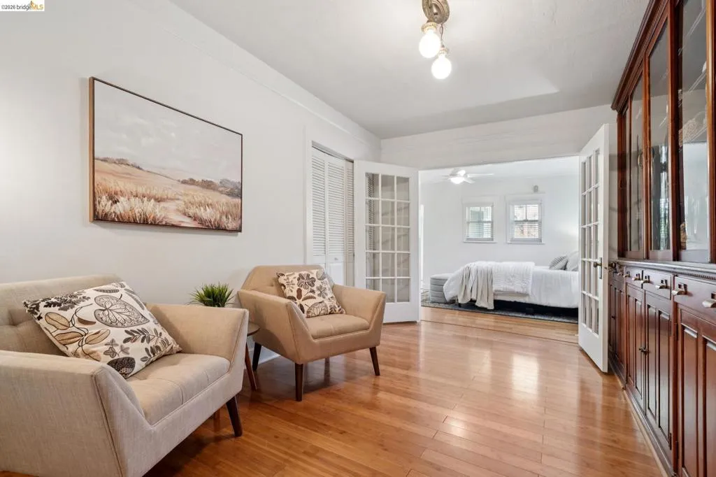 Hardwood flooring throughout, featuring a built-in wood-finish display cabinet with glass-front uppers and solid lower cabinets