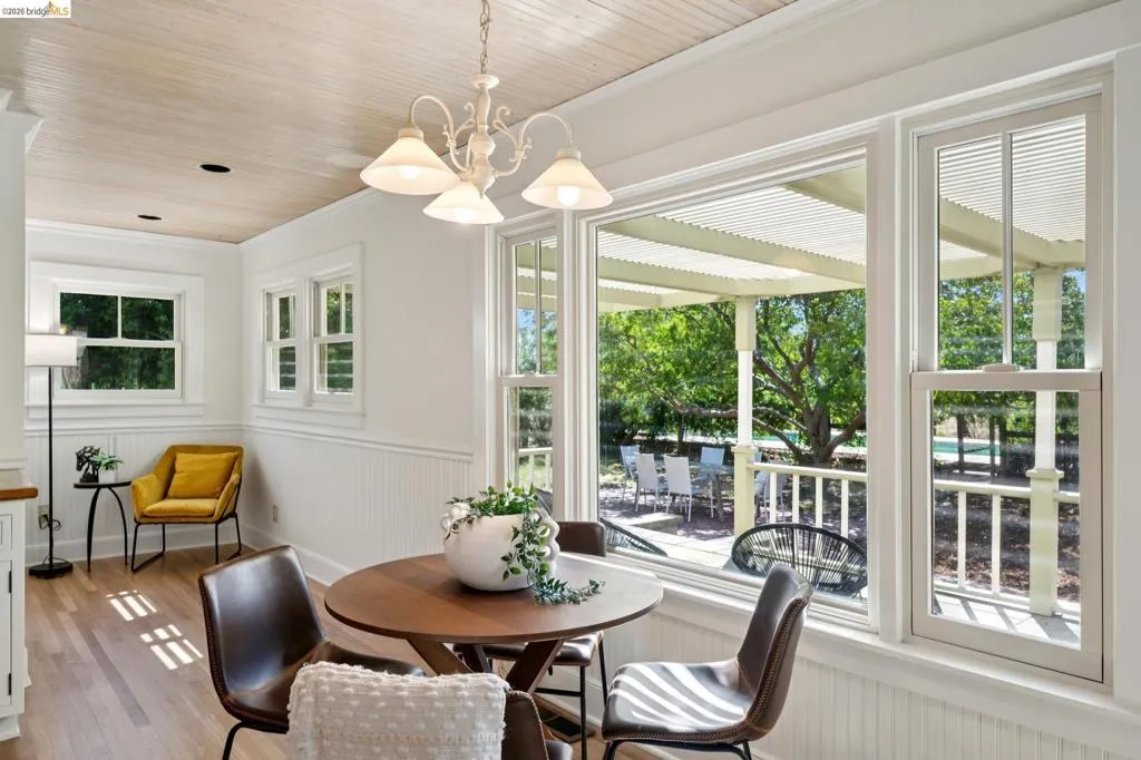 Dining area with wood-finish flooring and a wood-paneled ceiling