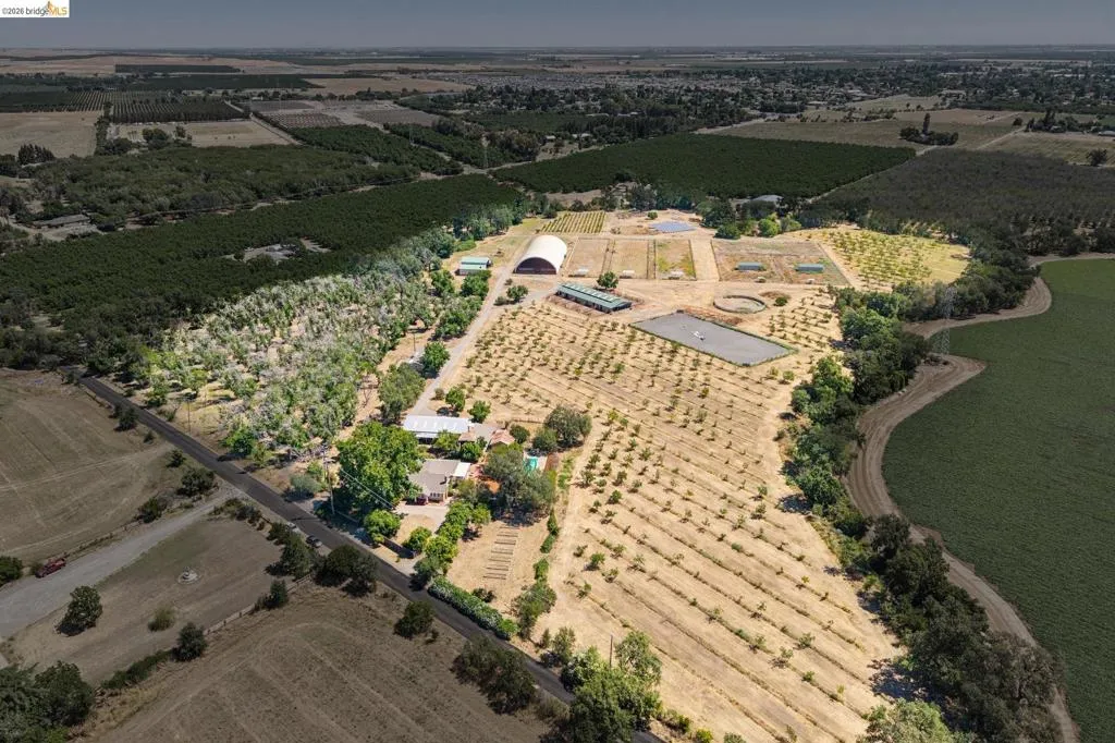 Expansive agricultural property featuring multiple cultivated fields and mature tree lines