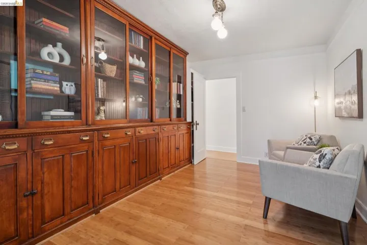 Built-in wood cabinetry with glass-front uppers and brass hardware