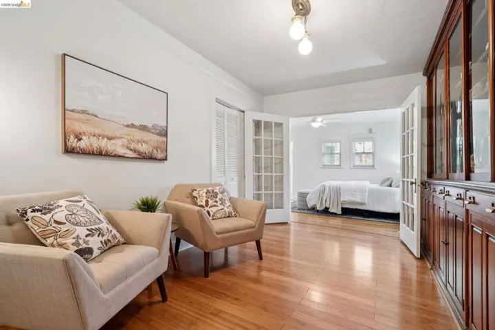 Hardwood flooring throughout, featuring a built-in wood-finish display cabinet with glass-front uppers and solid lower cabinets