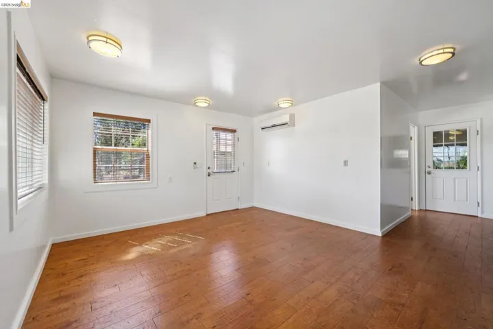 Bright interior space featuring wood-finish flooring and white walls