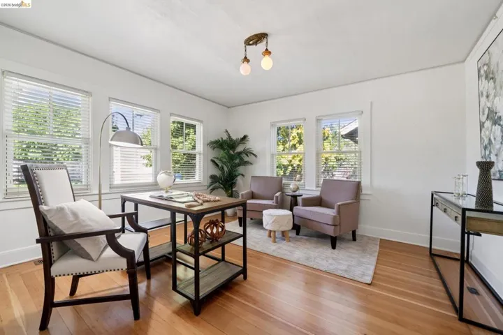 Bright room featuring wood-finish flooring and multiple windows with blinds