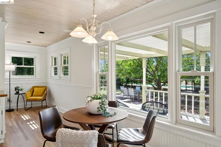 Dining area with wood-finish flooring and a wood-paneled ceiling