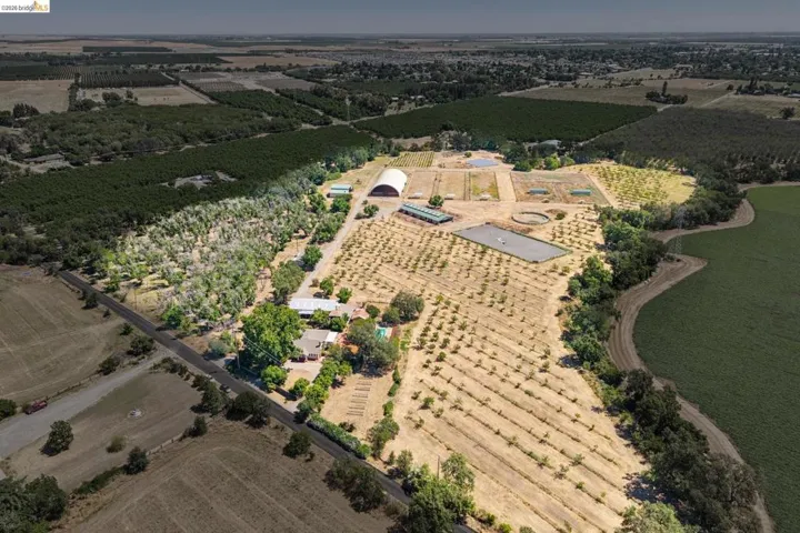Expansive agricultural property featuring multiple cultivated fields and mature tree lines