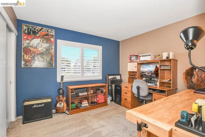 Home office featuring light carpet