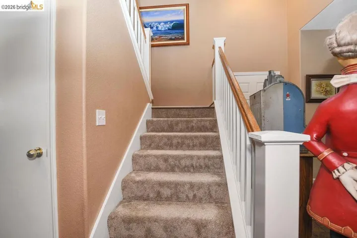 Stairs with baseboards and carpet