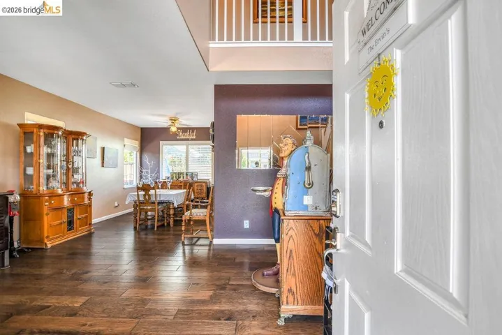Entrance foyer featuring dark wood-type flooring and ceiling fan