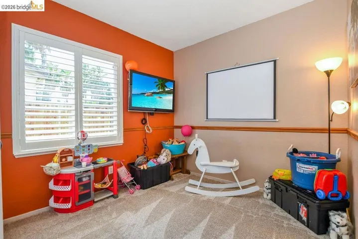 Recreation room featuring light colored carpet