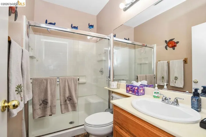 Full bathroom with vanity and a stall shower