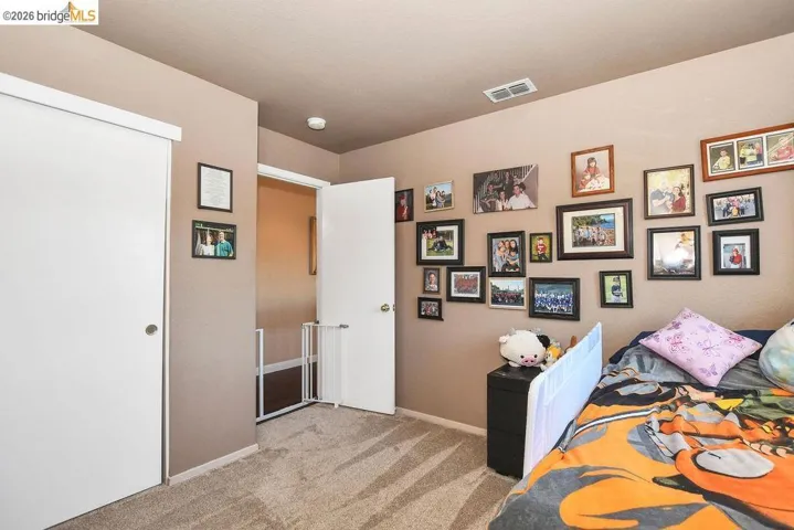 Bedroom featuring light colored carpet and baseboards