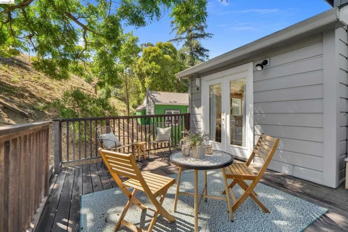 Expansive wood deck with a natural wood railing, offering a private outdoor space
