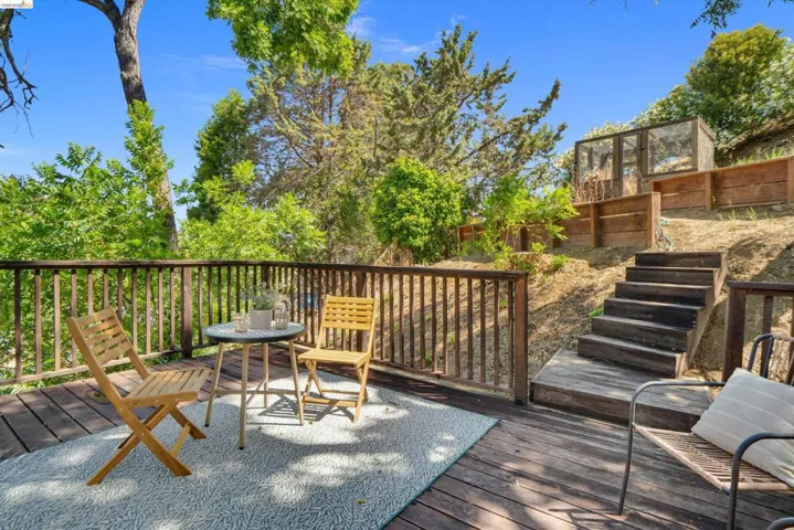 Expansive wooden deck featuring a slatted railing, providing an outdoor living area