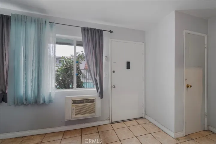 Entrance wth view of the pool. Coat closet to the right before the stairs.
