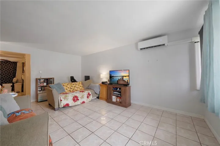 Split zone system in the living room with tile flooring.