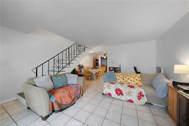 Living room with tile flows to the dining area. Lower level half bath not shown.