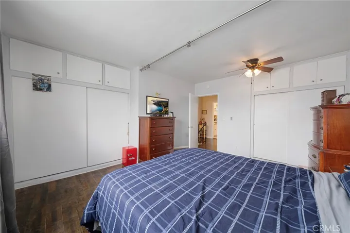 Upstairs roomy bedroom with ceiling fan.