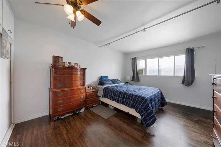 Upstairs roomy bedroom with ceiling fan. Window view of the community pool.