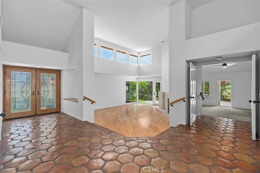 Large living room and spacious primary bedroom both opening to the backyard.