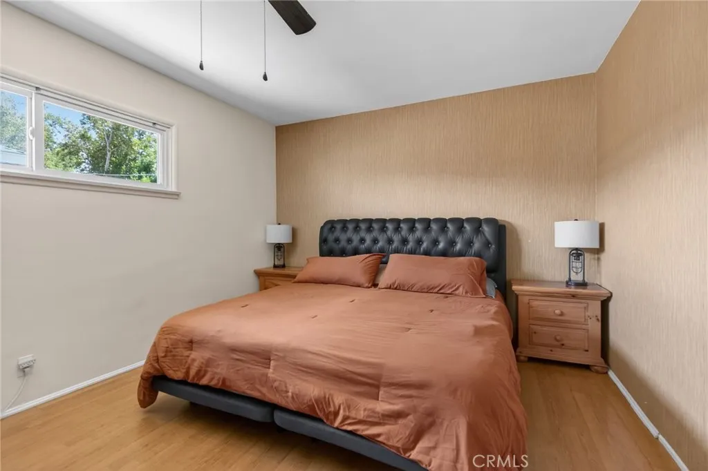 Primary bedroom with ceiling fan and sense of privacy and quiet.