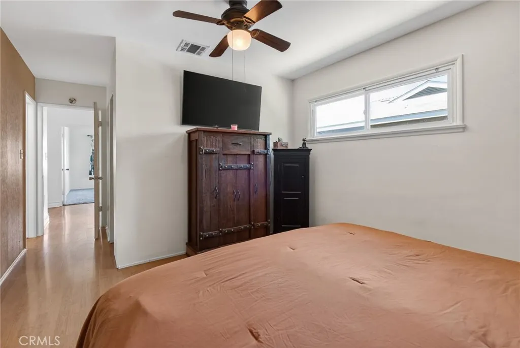 Alternate view of primary bedroom with ceiling fan and a walk-in closet!