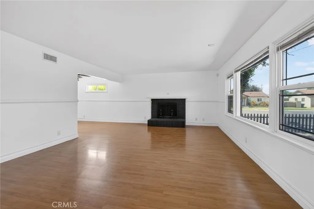 Spacious living room with double pane windows and fireplace.