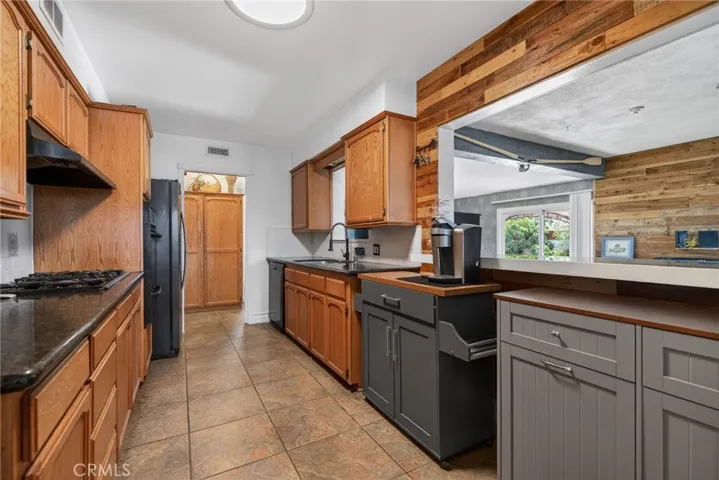 Updated kitchen with large pass-through to the bonus room, convenient for chatting with guests while they are shooting pool.