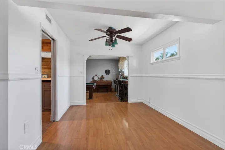 Formal Dining Room with kitchen to the left and step-down bonus room for pool table and bar area straight ahead.