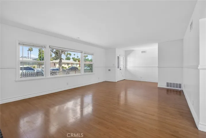 Spacious living room with double pane windows and fireplace.