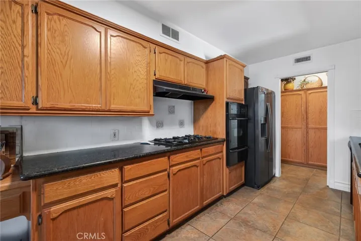 Solid counter tops, gas cook top, and large pantry. And refrigerator stays.