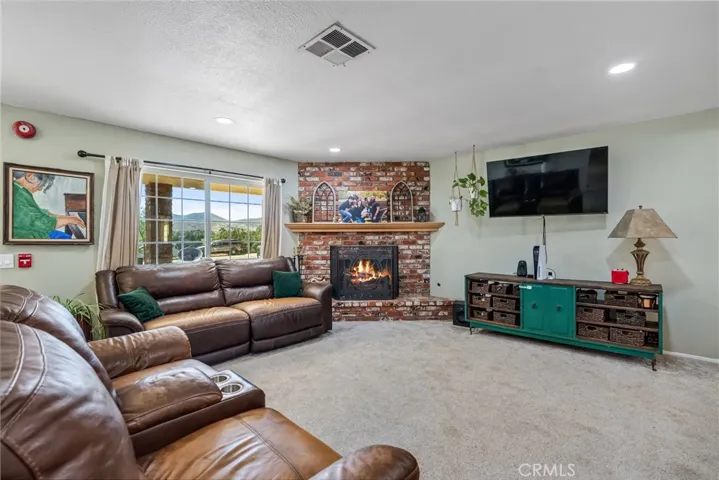 virtually staged/altered with flames in fireplace