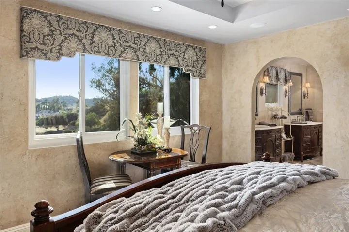 The primary bedroom offers stunning hill views