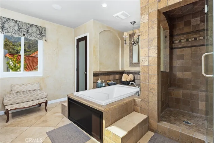 The elegant primary bathroom with a huge jetted tub for soothing sore muscles