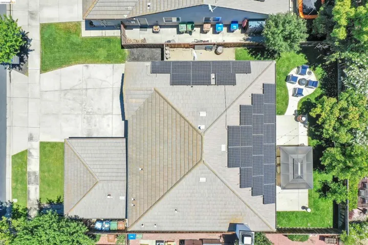 Expansive tiled roof featuring multiple solar panel arrays