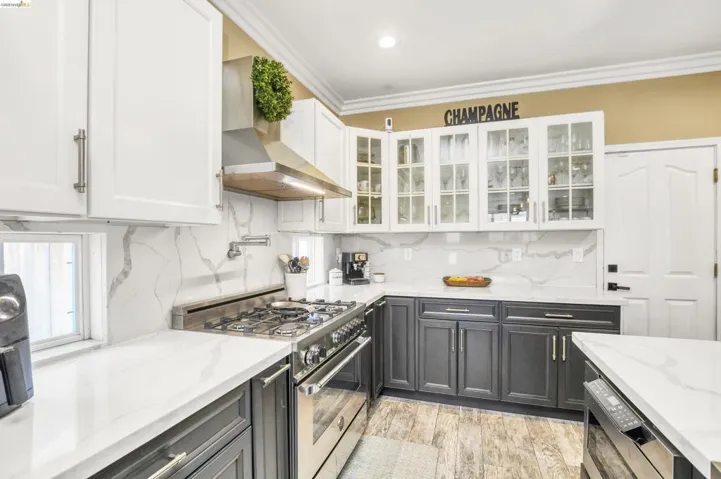 Contemporary kitchen featuring white shaker upper cabinetry and dark lower cabinetry