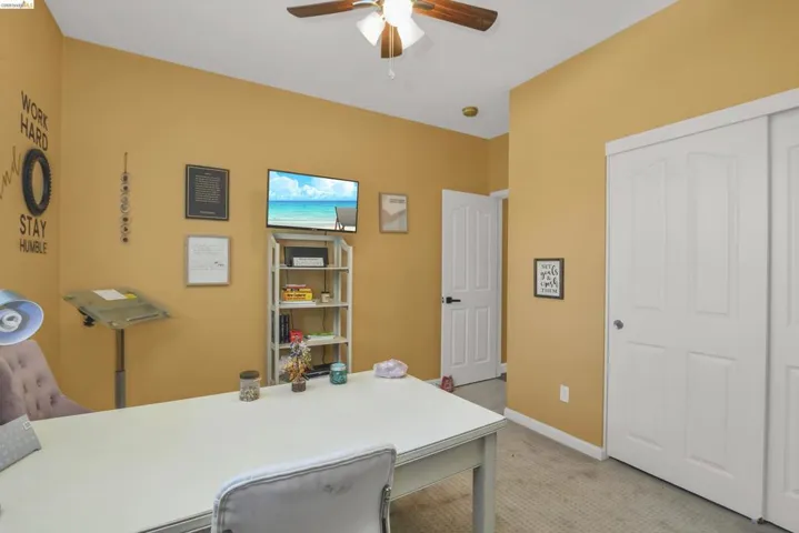Carpeted room featuring a ceiling fan, recessed lighting, and a double-door closet with white paneled doors
