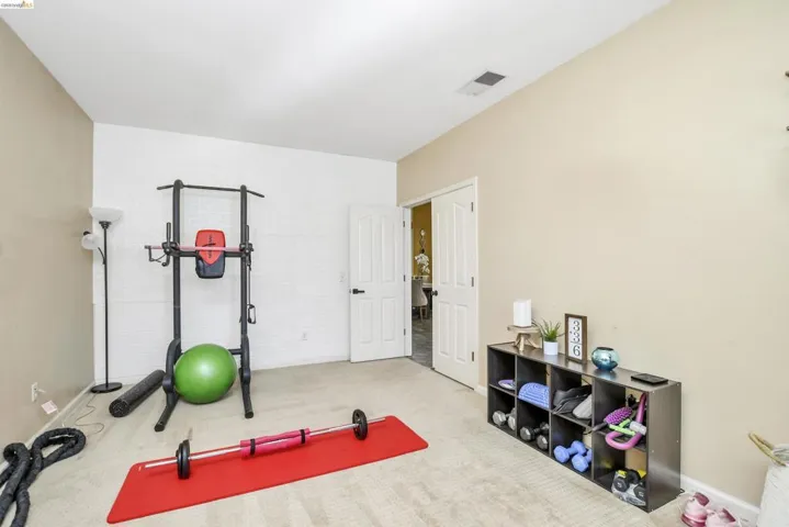 Spacious room with light-toned carpeting and neutral wall paint
