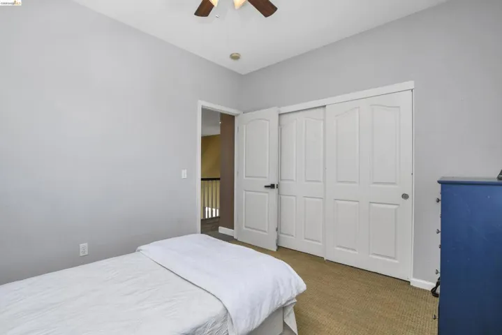 Room with neutral gray walls and light brown carpeted flooring