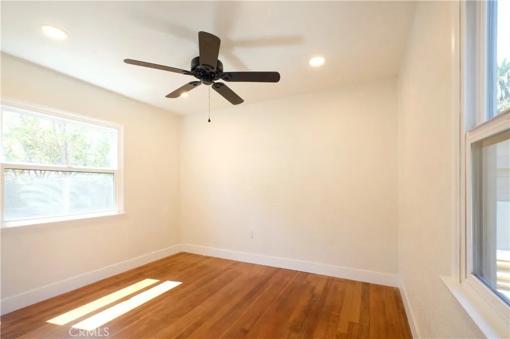 Bedroom 3 hardwood floor, recessed lighting, backyard view