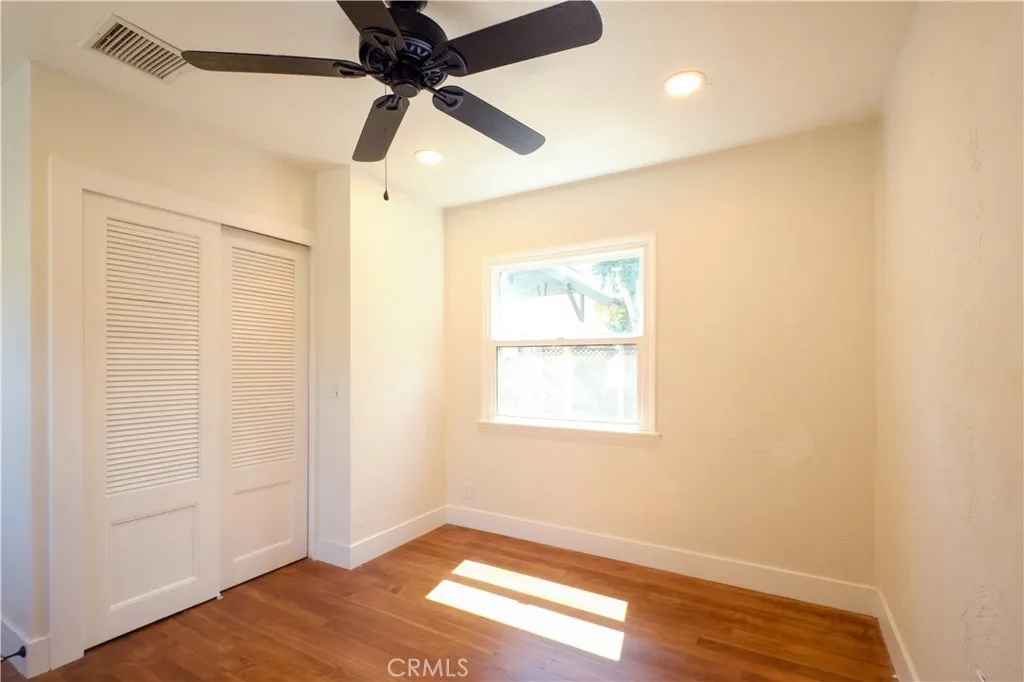 Bedroom 3 hardwood floor, recessed lighting, backyard view