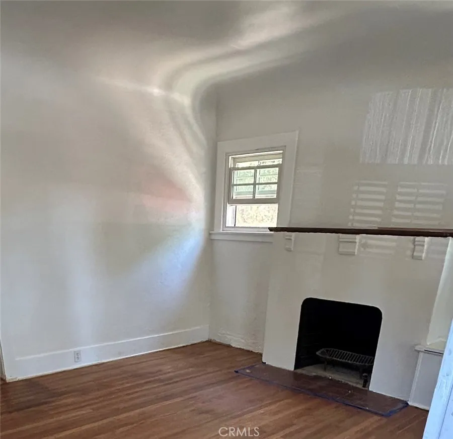 Front room and wood burning fireplace and hardwood floors