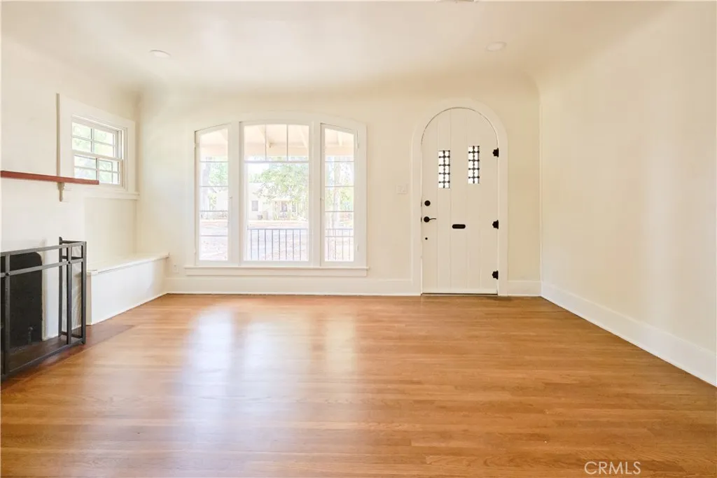 Living space with fireplace, wood flooring, recessed lighting throughout house