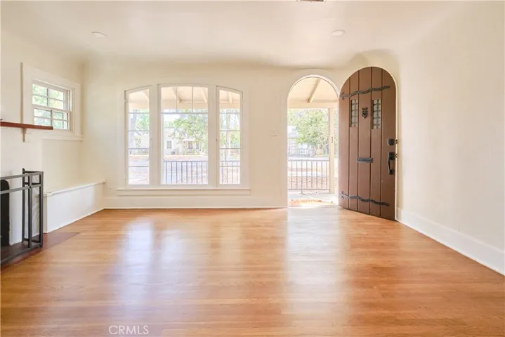 Living space with fireplace, wood flooring, recessed lighting throughout house